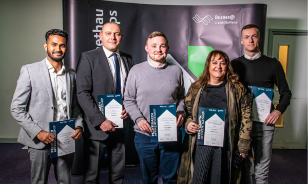 The health and social care and hospitality industries across North Wales dominated Grŵp Llandrillo Menai’s Work Based Learning Awards 2025 ceremony.The awards ceremony, held at Venue Cymru and sponsored by Babcock International Group, celebrated work-based learning winners and employers across North Wales who benefit from apprenticeships delivered for the Welsh Government by Grŵp Llandrillo Menai and its consortium partners William Holmes from MHC UK Ltd in Denbigh, which care for people with learning disabilities, was named Higher Apprentice of the Year, Naganarayanan Ramamoorthy, a chef at St George’s Hotel, Llandudno, won the Foundation Apprentice of the Year Award, Liam Ossian Thomas, head chef at Wal Restaurant, Caernarfon, was named Apprentice of the Year and Ysgol Gwynedd primary school in Flintshire, represented by Dewi Wyn Hughes, won the Work-based Learning Employer of the Year. Seren Ffestiniog, Blaenau Ffestiniog, won the Employer of the Year while Jenny Thomas, of Tyddyn Môn, Dulas, Anglesey was named Welsh medium Apprentice of the Year. Both awards were sponsored by Coleg Cymraeg Cenedlaethol. Gwenllian Roberts, Busnes@LlandrilloMenai’s Executive Director - Commercial Development, said: “The awards have brought into sharp focus how apprenticeships and work based learning directly contribute to the economic growth of our region and the vitality of our communities. “We’ve all been inspired by the stories of our finalists and winners and it has been particularly good to see the health and social care and hospitality sectors strongly represented in this year’s awards. “Through the support and training from Grŵp Llandrillo Menai and our consortium partners we’re really proud to be able to help people develop rewarding careers and this evening has shone a light on how apprenticeships open up pathways to career progression. “Liam has gone from pot washer in the kitchen to head chef at Y Wal, Caernarfon, Naga has been promoted to a junior management position at St George’s Hotel, Llandudno and Billy has progressed from a foundation apprenticeship all the way up to registered manager. “The awards have also allowed us to celebrate and recognise the crucial role employers play in supporting apprentices. I’m delighted how the employer awards introduced this year have shown how apprenticeships support businesses to develop their workforce by nurturing talent from within. “It was fantastic to celebrate the work of two outstanding social enterprises, Tyddyn Môn and Seren Ffestiniog, who brought alive how important learning through the medium of Welsh is for delivering much needed services in communities. “Ysgol Gwynedd Primary school in Flint, winner of the Work Based Learning Employer of the Year, inspired us all by their passion for developing and growing their people and incredible commitment to learning.” More about the North Wales Work-Based Learning Awards and winners More than 60 nominations were received in total for the awards and candidates were shortlisted based on their contribution to the workplace, their progression and commitment to learning. The ‘Apprentices of the Year’ were chosen by an online vote, while the specialist categories were considered by a specialist panel of experts. Each winner has made a real contribution to their workplace and used the apprenticeship programme to progress their careers, while our Ysgol Gwynedd and Seren Ffestiniog have proved that work based learning training can deliver real value for employers. William Holmes was recognised for his exceptional leadership, innovation and dedication to improving health and social care services. He delivered a project to not only introduce life-saving defibrillators at MHC UK Ltd but also trained staff how to use them in an emergency, as part of their care for the elderly or vulnerable. The project was part of William’s Higher Apprenticeship (Level 5) in Leadership and Management of Health and Social Care Practice. His focus on education and training not only increased staff confidence in handling emergency situations but also raised overall awareness of the importance of cardiac health. Described as a role model for future chef apprentices, Naganarayanan Ramamoorthy moved to Wales in 2023 with the goal of gaining knowledge and experience for a career in the culinary arts. His dedication to learn, progress and support others have earned him promotion to a junior management position at St George’s Hotel. He completed a City & Guilds Level 2 Diploma in Food Production and Cooking three months early and has displayed a high level of professionalism. Liam Thomas is described by his assessor as “a true champion of work-based learning”, leading by example to encourage colleagues to become apprentices. He progressed from a Foundation Apprenticeship in Professional Cookery to complete an Apprenticeship in Hospitality Supervision & Leadership, boosting his cooking and leadership skills along the way. He has helped his employers to expand by opening Woodfire Pizza restaurant, after attending masterclasses with an Italian pizza expert, researching equipment required and contributing to a business plan. He has also attended a range of other masterclasses to learn about global cuisines and is happy to share his knowledge and skills with colleagues. His employers say Liam has brought flare and excitement to both their restaurants. Both Aled Williams, of Cwmni Seren Ffestiniog, and Jenny Thomas, at Tyddyn Môn, highlighted the importance of learners being trained through the medium of Welsh and servicing and caring for communities. Ysgol Gwynedd was awarded Work Based Learning Employer of the Year for its strategic use of apprenticeships to support workforce planning and development. Award finalists were: Foundation Apprentice of the Year, Timothy Dykins, Ryan Wood, Jade Botha and Sadie Gittins. Apprentice of the Year, Ebony Riordan, Fiorella Wyn Roberts, Gareth Jones, Leanne Atlee, and Nash Costigan. Higher Apprentice of the Year, Naomi Archer and Darren Morris.
