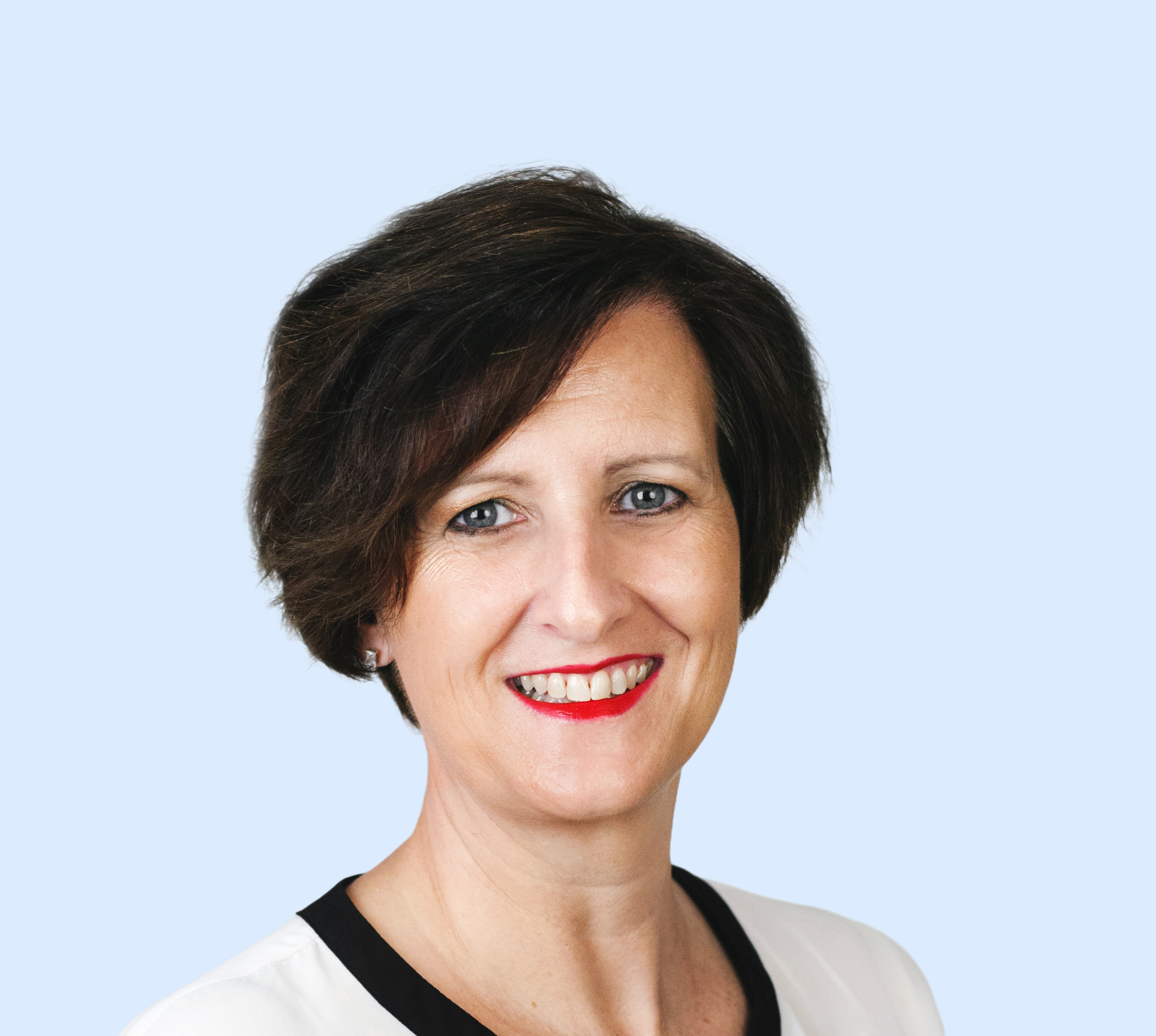 Emma Prodromou - Headshot - Blue Background Emma Prodromou - Headshot - Blue Background